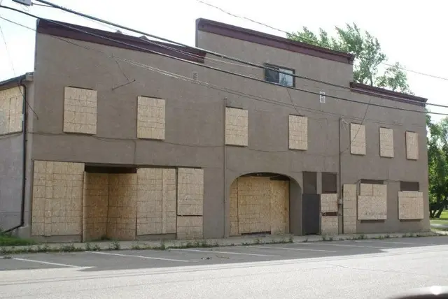Boarded-up bakery and theatre building